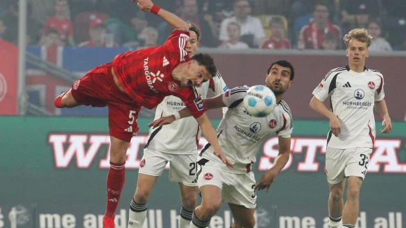 Düsseldorfs Moritz Heyer (l) klärt artistisch vor Nürnbergs Mahir Emreli. - © Roland Weihrauch/dpa