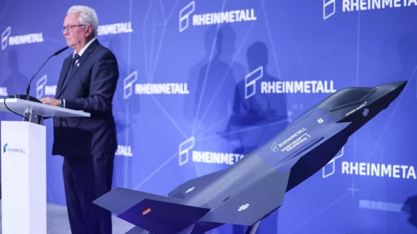 Ein Modell des F-35 auf der Bühne, auf der Konzernchef Papperger zu Mitarbeitern spricht. - © Oliver Berg/dpa