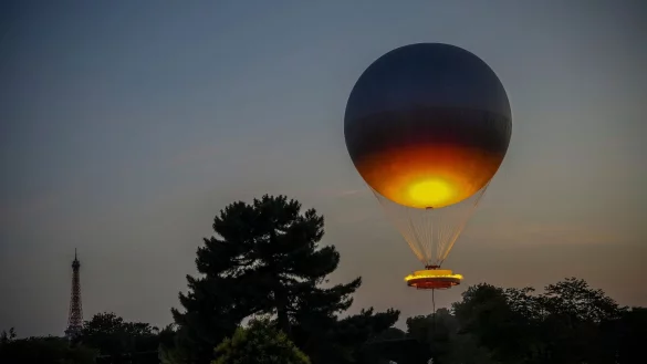 Viele Menschen in Paris hatten sich gewünscht, dass der olympische Ballon wieder in die Stadt zurückkehrt. - © Aurelien Morissard/AP/dpa