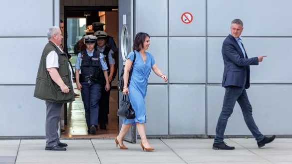 Außenministerin Annalena Baerbock (Bündnis90/Grüne) geht nach ihrer Landung auf dem Flughafen Hamburg hinter einem Sicherheitsbeamten zu ihrem Fahrzeug. - © Markus Scholz/dpa