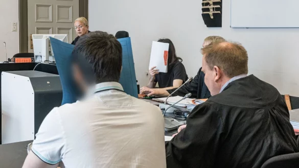 Die beiden Angeklagten verbergen in der Hauptverhandlung im Gerichtssaal ihre Gesichter hinter Aktenordnern. - © Markus Scholz/dpa