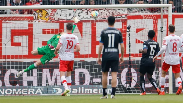 Regensburg-Keeper Jonas Urbig (M) war beim Magdeburger F&uuml;hrungstreffer chancenlos. - &copy; Daniel L&ouml;b/dpa
