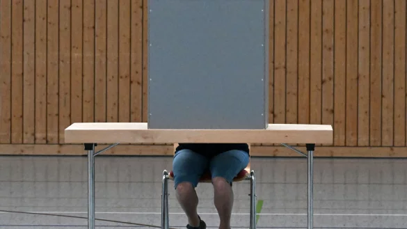 Eine Frau gibt in einem Wahllokal ihre Stimme ab. - © Martin Schutt/dpa