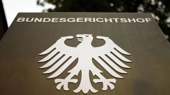 Ein Hinweisschild mit dem Bundesadler steht vor dem Bundesgerichtshof (BGH) in Karlsruhe. - &copy; Uli Deck/dpa/Symbolbild