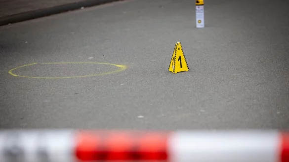 Markierungen der Spurensicherung auf dem Boden am Tatort des Angriffs auf zwei Kinder, einige Meter von einer Schule entfernt. Auf einem kleinen Parkplatz hat die Polizei Flatterband gespannt und alles abgesperrt. - &copy; Christoph Reichwein/dpa