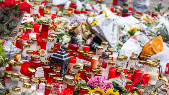 Kerzen und Blumen liegen vor dem Eingang der Waldbachschule. - &copy; Philipp von Ditfurth/dpa