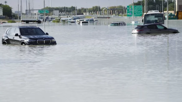 Fahrzeuge stehen verlassen im Hochwasser auf einer Hauptstra&szlig;e in Dubai. - &copy; Jon Gambrell/AP/dpa