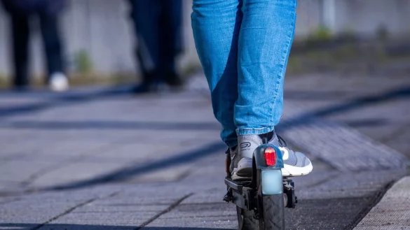 Ein Reisender f&auml;hrt mit seinem E-Scooter &uuml;ber den Bahnsteig. - &copy; Jens B&uuml;ttner/dpa