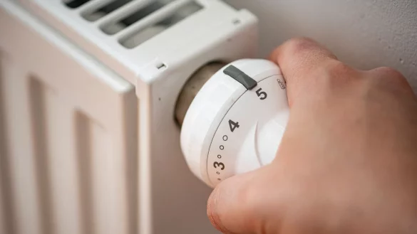 Eine Mann dreht die Heizung auf. - © Fabian Sommer/dpa/Symbolbild