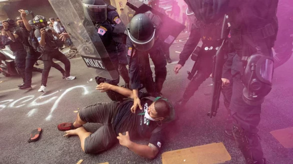 Polizisten im Clinch mit einem Demonstranten, der zusammen mit weiteren versucht, zum Veranstaltungsort des Apec-Gipfels zu gelangen. - &copy; Wason Wanichakorn/AP/dpa