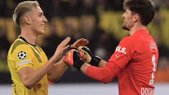 Dortmunds Torwart Gregor Kobel (r) klatscht mit Nico Schlotterbeck nach gehaltenem Elfmeter ab. - © Bernd Thissen/dpa