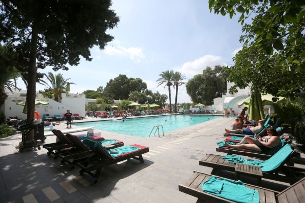 Urlauber entspannen am Swimmingpool eines Hotels in Tunesien. - © Mohamed Krit/BELGA/dpa