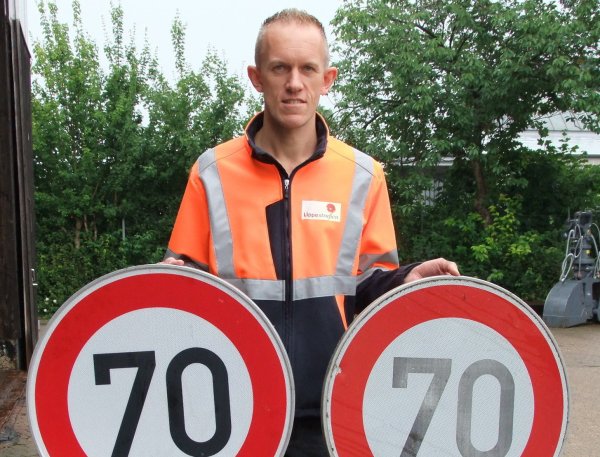 Frank Rehberg ist Leiter des zentralen Bauhofes in Lieme. Hier hält er ein Schild hoch, das regelmäßig auf den Kreisstraßen erneuert werden muss. - © Axel Bürger