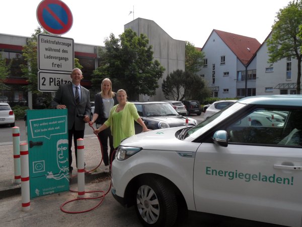 Mit dem Stecker in der Hand: (von links) Bürgermeister Stefan Rother, Leonie Riekschnietz (Westfalen Weser Netz) und Malena Podranski von der Stadtverwaltung weihen die Säule ein. - © Privat