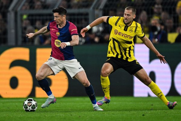 Barcelonas Robert Lewandowski (l) und Dortmunds Waldemar Anton kämpfen um den Ball. - © Federico Gambarini/dpa