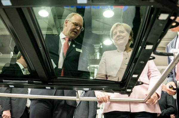 Der scheidende Webasto-Chef Holger Engelmann in besseren Tagen im Jahr 2019. Hier demonstriert der Manager der früheren Bundeskanzlerin Angela Merkel in einem Werk im chinesischen Wuhan die Fertigung von Schiebedächern. - © Michael Kappeler/dpa