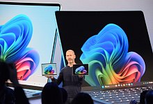 Microsoft-Manager Brett Ostrum zeigt ein Notebook und ein Tablet - Andrej Sokolow/dpa