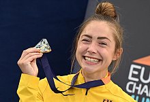 Gina Lückenkemper freut sich bei der Siegerehrung über ihre Goldmedaille. - Angelika Warmuth/dpa