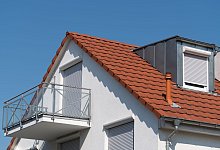 Wohnhaus mit einem Balkon am Giebel - Uwe Anspach/dpa-tmn