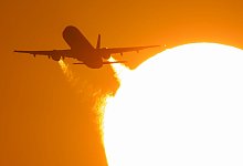 Flugzeug bei Sonnenuntergang - Boris Roessler/dpa