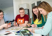 Eine Gruppe spielt ein Gesellschaftsspiel - Benjamin Nolte/dpa-tmn