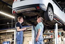 Zwei Männer arbeiten gemeinsam in einer Autowerkstatt - Benjamin Nolte/dpa-tmn