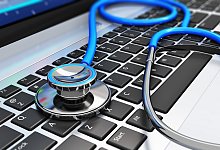 Stethoscope on laptop keyboard - Getty Images