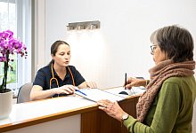 Eine Patientin wird von einer Sprechstundenhilfe beraten - Benjamin Nolte/dpa-tmn