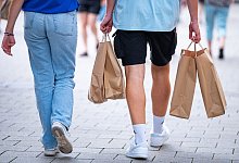 Menschen in einer Fußgängerzone mit Papiertüten beim Shopping - Jonas Walzberg/dpa/dpa-tmn