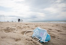 Mundschutz am Strand - Foto: Christian Charisius/dpa