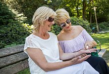 Zwei Frauen sitzen auf einer Bank - Christin Klose/dpa-tmn/dpa