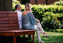 EIn Mann und eine Frau sitzen auf einer Bank - Zacharie Scheurer/dpa-tmn