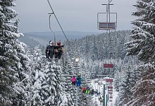 Skifahrer sitzen in einem Skilift. Trotz versch&auml;rfter Corona-Regeln k&ouml;nnen Skifahrer die Lifte in Th&uuml;ringen mit 3G-Nachweis nutzen. - Candy Welz/dpa-Zentralbild/dpa/Archiv