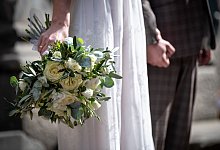 Brautpaar steht vor dem Standesamt - Sina Schuldt/dpa/dpa-tmn