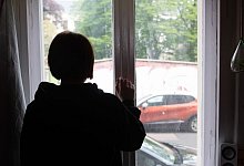 Eine Jugendliche blickt aus einem Fenster - Paul Zinken/dpa