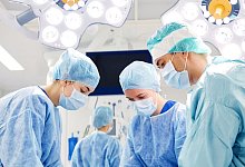 group of surgeons in operating room at hospital - lev dolgachov