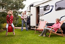 Family Enjoying Camping Holiday In Camper Van - omgimages