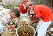 Ein Kameramann filmt im selbst ernannten YouTube-Dorf die Zubereitung von Hammelcurry, um es anschließend mehr als 100 Waisenkindern einer religiösen Schule zu servieren.K - Nazrul Islam/dpa