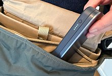 Mann steckt eine Powerbank in seinen Rucksack - Till Simon Nagel/dpa-tmn