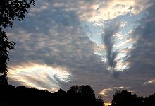 Der Anblick &uuml;ber L&uuml;bbecke: Zwei Hole Punch Clouds geben den Blick auf den Himmel frei. - Friedrich F&ouml;st