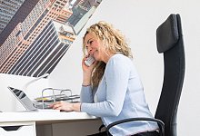 Frau spricht im Büro am Telefon - Christin Klose/dpa-tmn