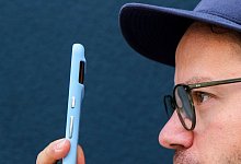 Ein Mann misst seine Körpertemperatur mit einem Smartphone - Zacharie Scheurer/dpa-tmn