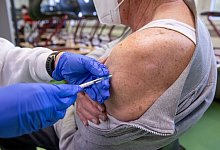 Ein Mann erh&auml;lt in einem mobilen Impfzentrum in Erlangen eine Auffrischungsimpfung gegen Covid-19. - Daniel Karmann/dpa