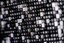 Eine fiktive Hackersoftware verschlüsselt in einer Maske auf dem Bildschirm Daten auf einer Festplatte. - Lino Mirgeler/dpa