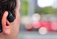 Open-Ear-Kopfhörer beim Laufen - Sebastian Christoph Gollnow/dpa