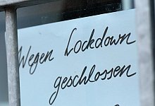 Ein Zettel weist auf eine Gesch&auml;ftsschlie&szlig;ung hin. - Foto: Arne Dedert/dpa/Symbolbild