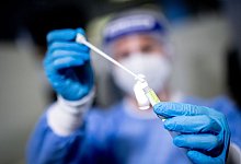 Eine medizinische Mitarbeiterin mit einem Abstrichst&auml;bchen - Matthias Balk/dpa/Symbolbild