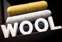 Woll-Textilien liegen hinter einem «Wool»-Schriftzug. - Alexander Heinl/dpa-tmn