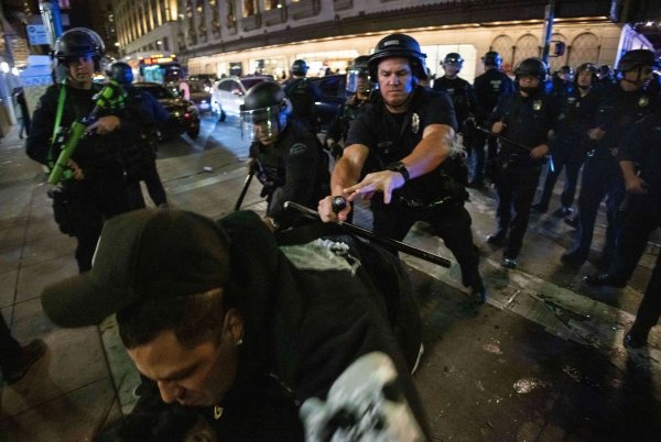 Dodgers Fans und die Polizei in Los Angeles liefern sich Auseinandersetzungen. - © Ethan Swope/AP/dpa