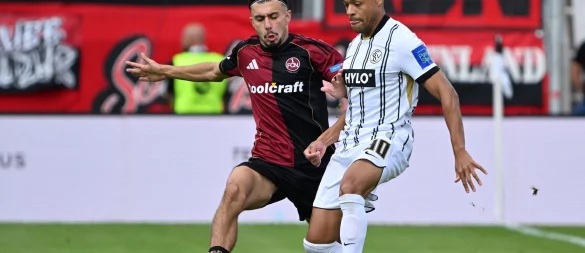 Die SV Elversberg um Jan Gyamerah (r) und der 1. FC Nürnberg um Berkay Y?lmaz lieferten sich einen umkämpften Zweitliga-Auftakt. - © Harald Tittel/dpa